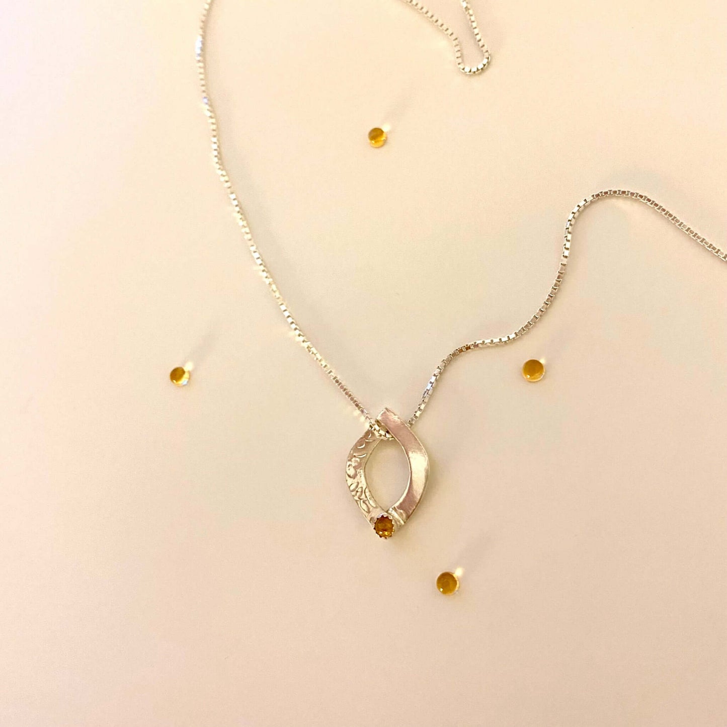Handmade oval silver pendant in two overlapping arches